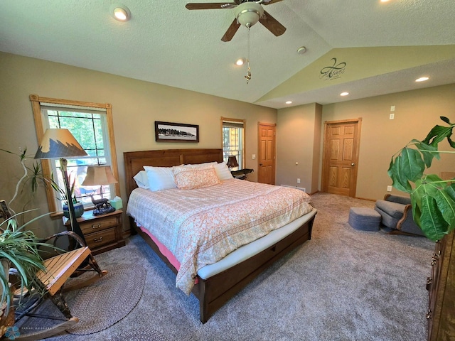 bedroom with multiple windows, lofted ceiling, ceiling fan, and carpet floors