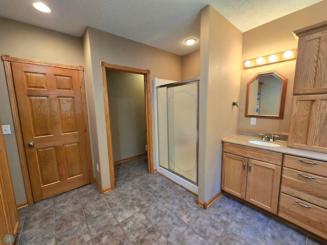 bathroom with vanity, an enclosed shower, and tile patterned floors