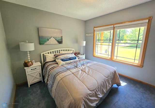 carpeted bedroom with a textured ceiling