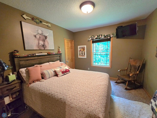 bedroom featuring carpet flooring and a textured ceiling