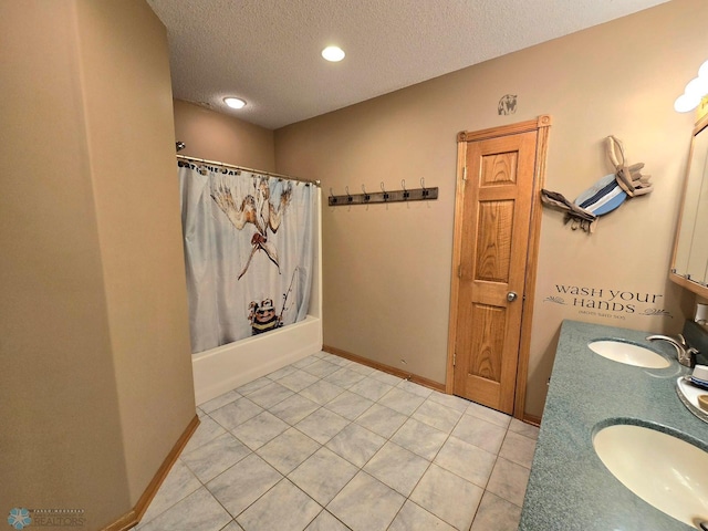 bathroom featuring tile patterned floors, shower / bath combo with shower curtain, a textured ceiling, and dual bowl vanity