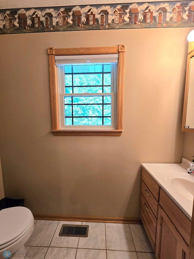 bathroom featuring tile patterned floors, vanity, and toilet