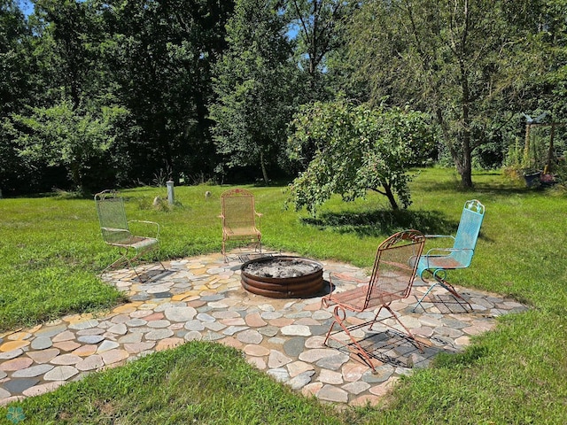 view of yard featuring a patio and an outdoor fire pit