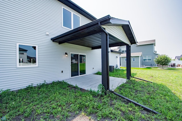 back of house with a patio, a lawn, and cooling unit