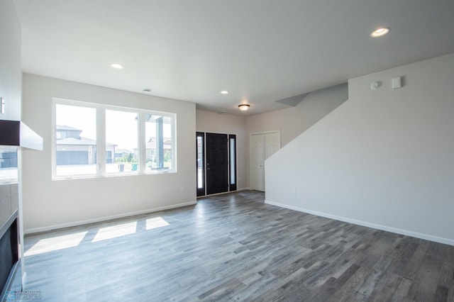 unfurnished living room featuring hardwood / wood-style flooring