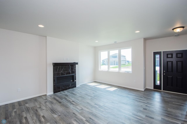 unfurnished living room featuring a fireplace and wood-type flooring