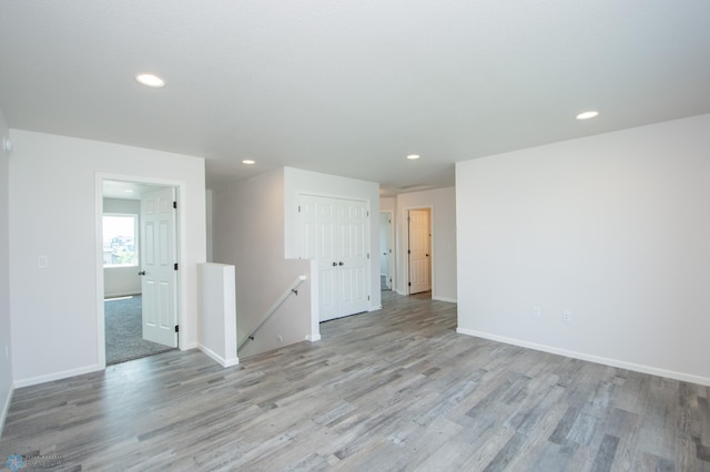 unfurnished room with hardwood / wood-style flooring