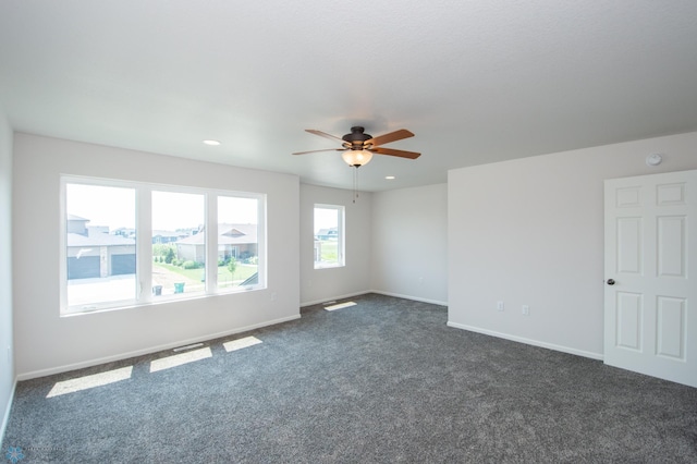 carpeted spare room featuring ceiling fan