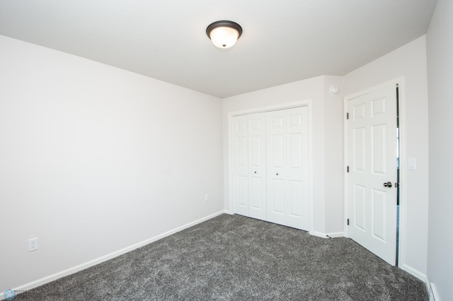 unfurnished bedroom featuring carpet and a closet