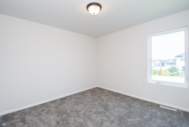 spare room featuring carpet