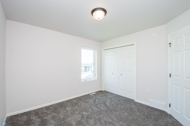 unfurnished bedroom with a closet and carpet floors