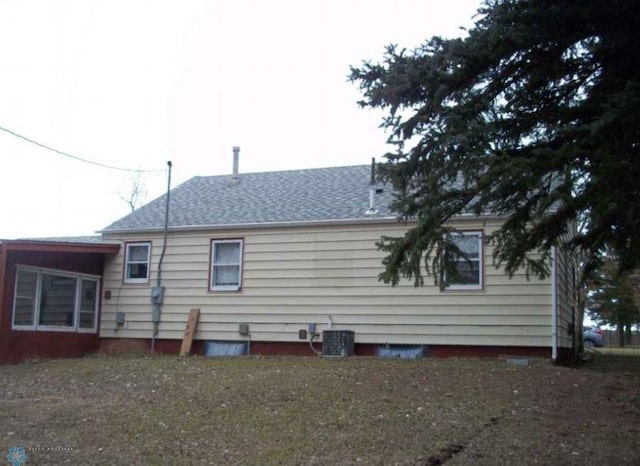 rear view of property with central air condition unit