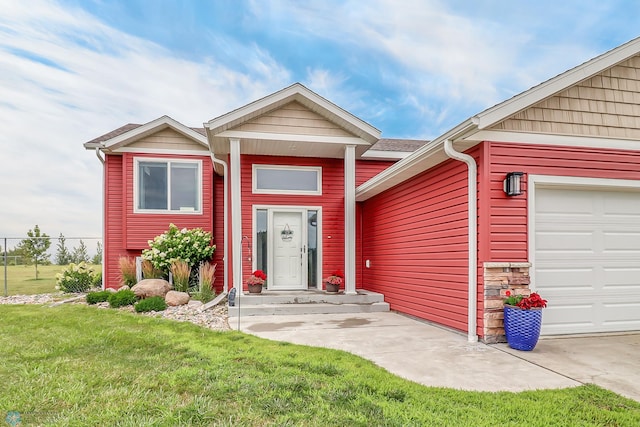 view of front of property with a garage and a front lawn