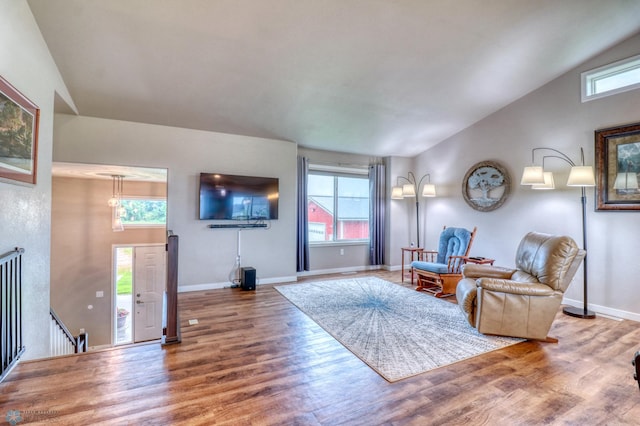 living room featuring hardwood / wood-style flooring and vaulted ceiling