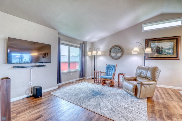 sitting room featuring hardwood / wood-style flooring and vaulted ceiling