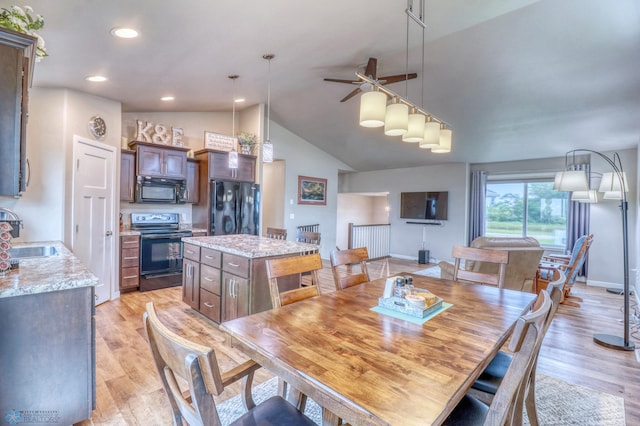 dining room featuring high vaulted ceiling, sink, light wood-type flooring, and ceiling fan