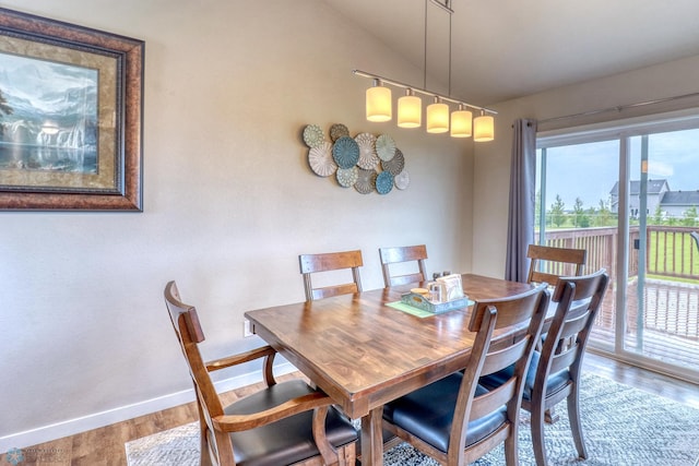 dining space featuring light hardwood / wood-style flooring and lofted ceiling