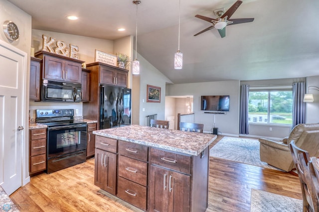 kitchen with a center island, ceiling fan, black appliances, and light hardwood / wood-style floors