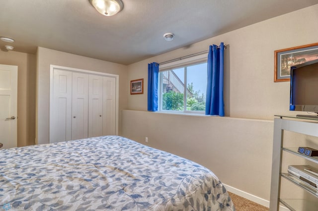 carpeted bedroom featuring a closet