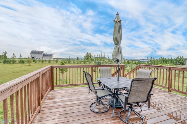 wooden deck featuring a lawn