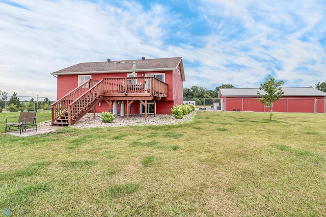 rear view of property featuring a wooden deck and a lawn