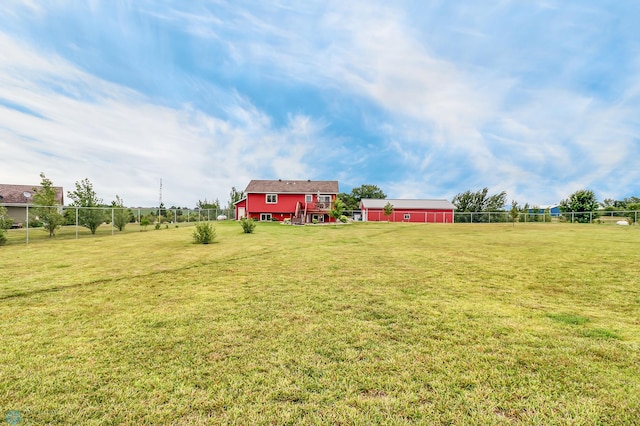 view of yard featuring a rural view and an outbuilding