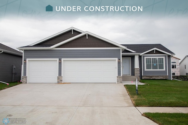 craftsman-style house with a garage and a front lawn