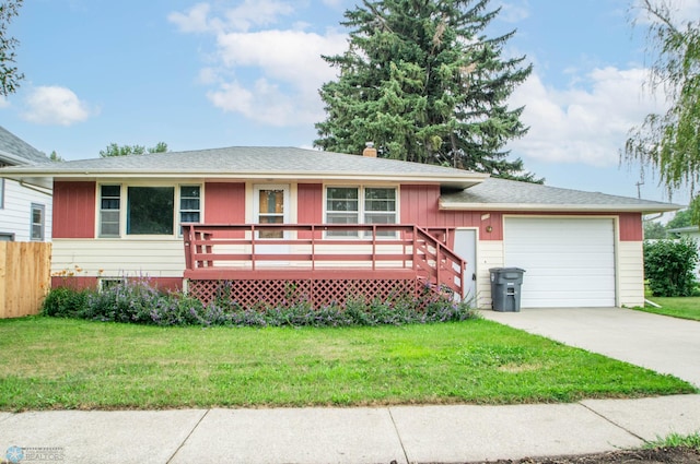 view of front of property with a garage, a wooden deck, and a front yard