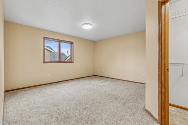 unfurnished bedroom featuring a closet and light carpet