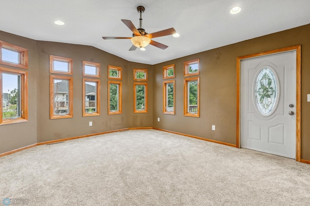 foyer featuring ceiling fan, carpet flooring, and vaulted ceiling