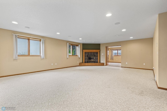 unfurnished living room featuring light carpet and a fireplace