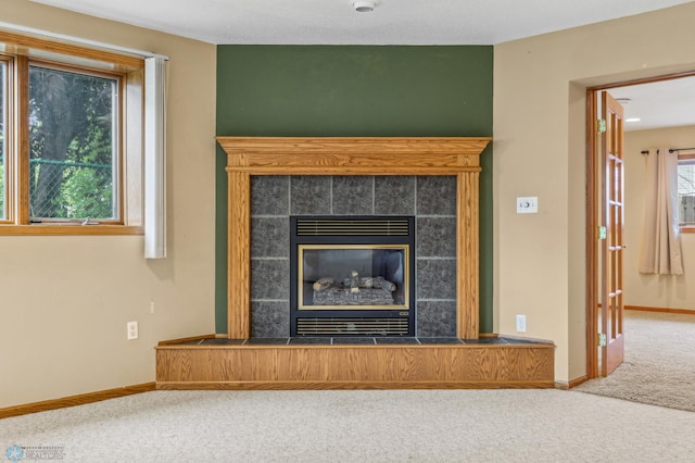 room details featuring carpet and a tiled fireplace