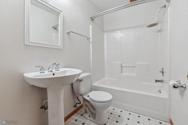 bathroom with tile patterned flooring, tub / shower combination, and toilet