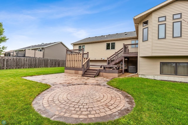 back of house with a deck, central AC, a patio area, and a yard