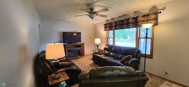 living room featuring a textured ceiling and ceiling fan