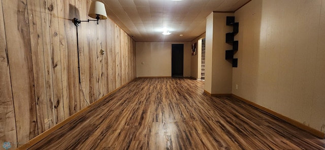 interior space with wood walls and dark wood-type flooring