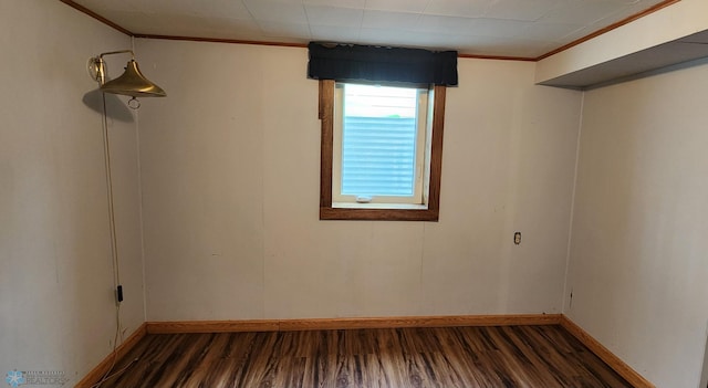 spare room featuring ornamental molding and hardwood / wood-style flooring