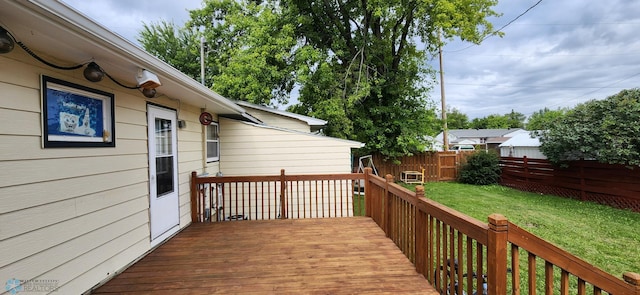 wooden terrace featuring a yard