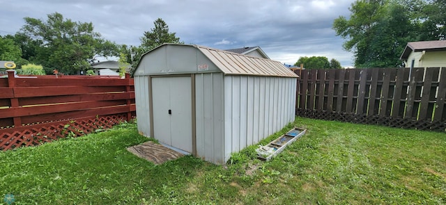 view of outbuilding featuring a lawn