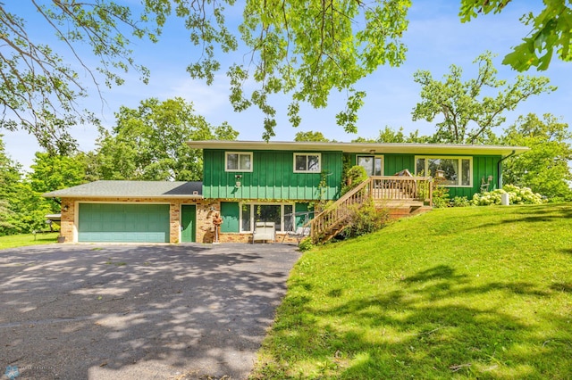 view of front of house with a front yard and a garage