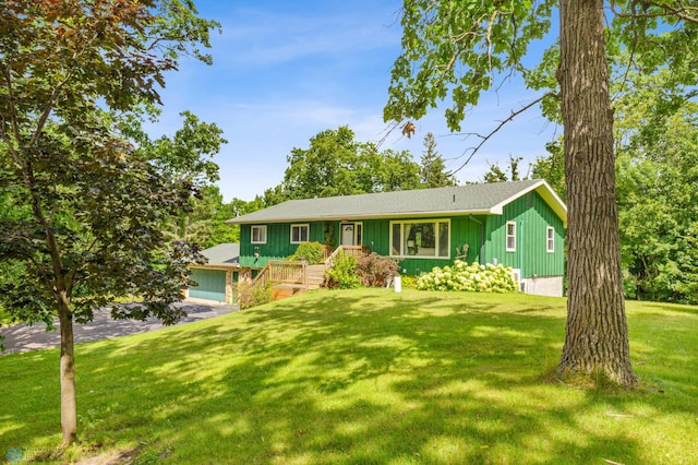 view of front of home with a front yard and a garage