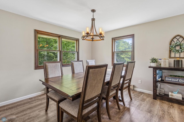 dining space featuring a notable chandelier and wood-type flooring