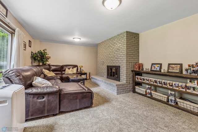 living room with brick wall, carpet floors, and a brick fireplace