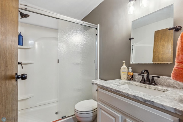 bathroom featuring walk in shower, toilet, and vanity