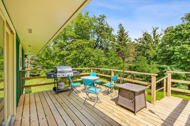 wooden terrace with a grill