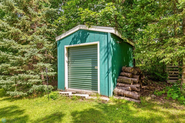 view of outbuilding with a yard