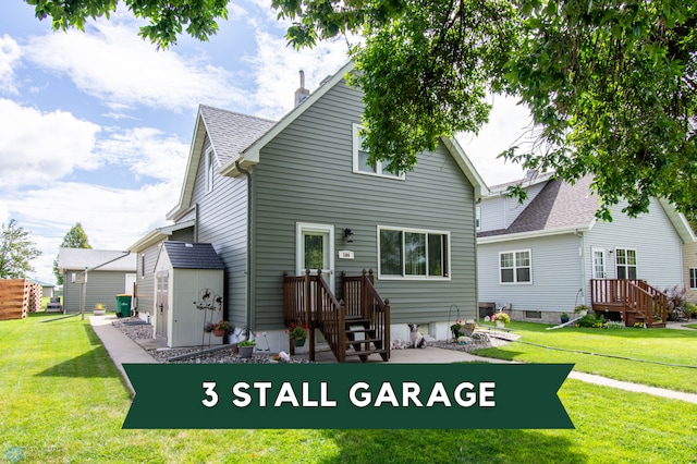 back of house featuring a lawn and a storage shed