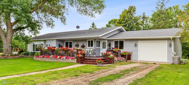 single story home featuring a front yard, a deck, and a garage