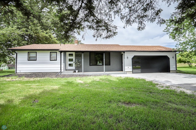 ranch-style home featuring a front lawn and a garage