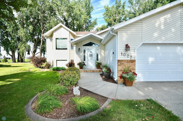 view of front of home with a garage and a front lawn